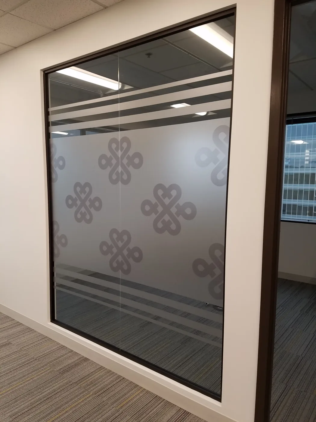 Frosted cut-vinyl privacy graphics on conference room glass wall — China Unicom San Jose
