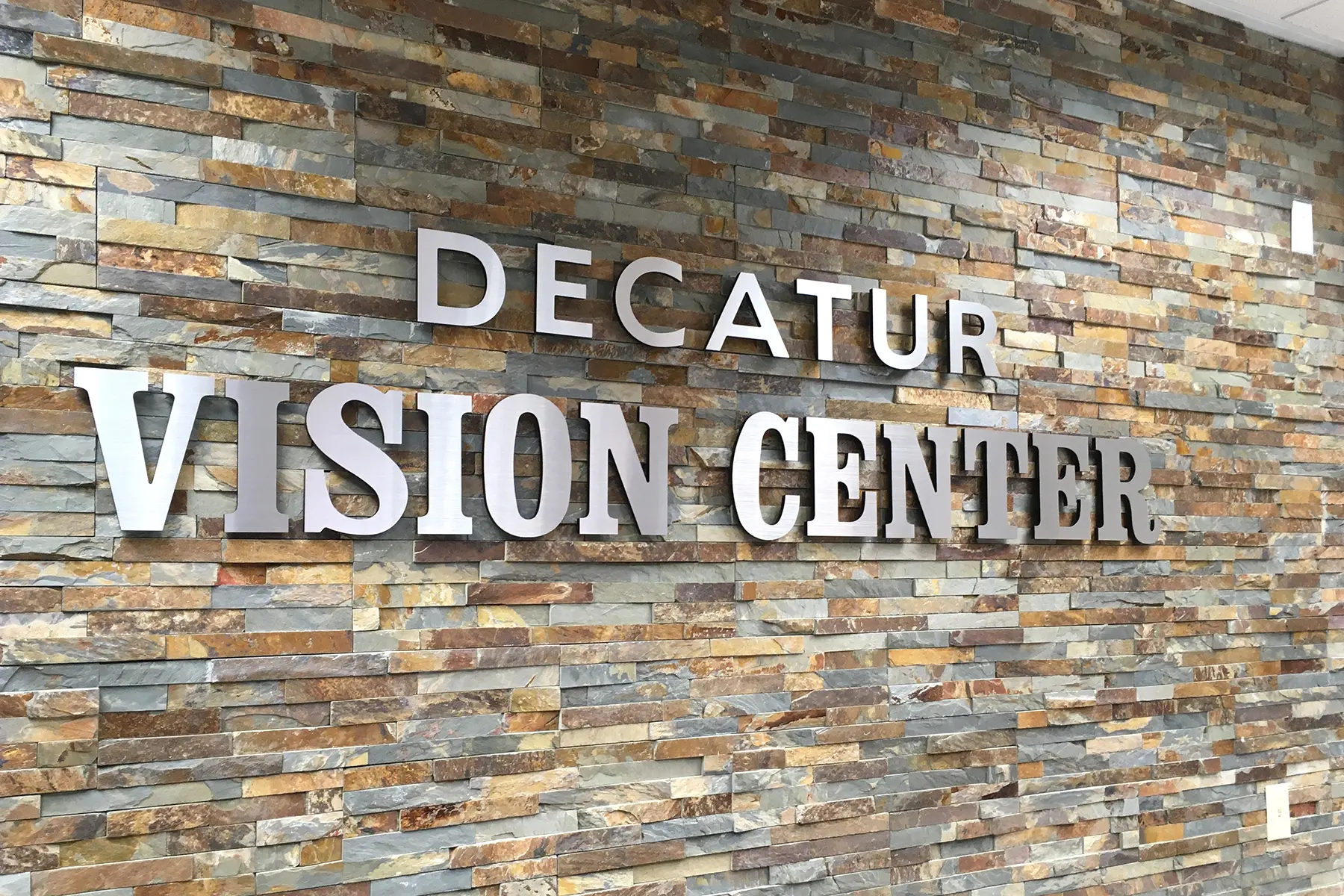Decatur Vision Center dimensional letters on stone wall — metal laminate on acrylic