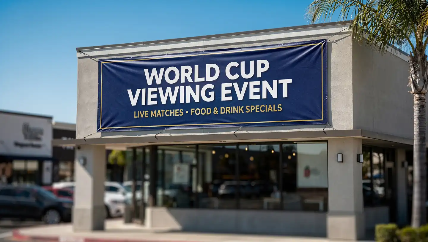 Outdoor vinyl banner reading World Cup Viewing Event on a California strip mall storefront